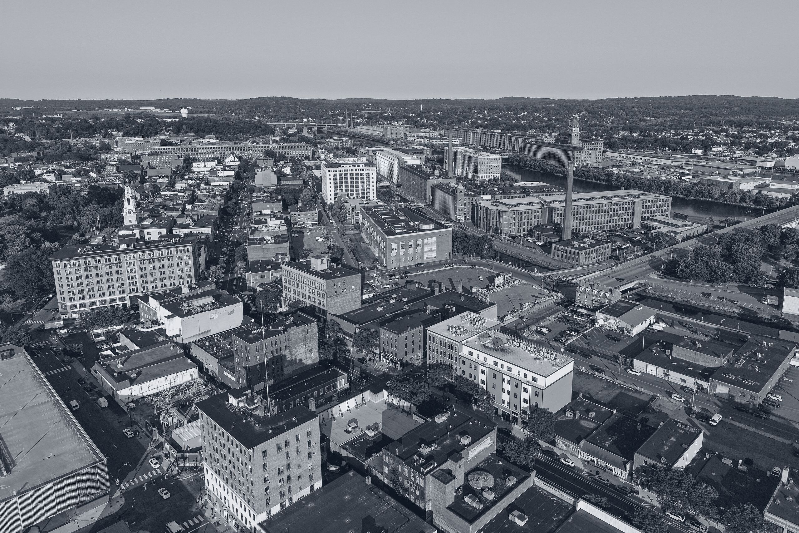 Downtown Lawrence, Massachusetts from above — mill buildings and the Ayer Mill clock tower along the Merrimack River