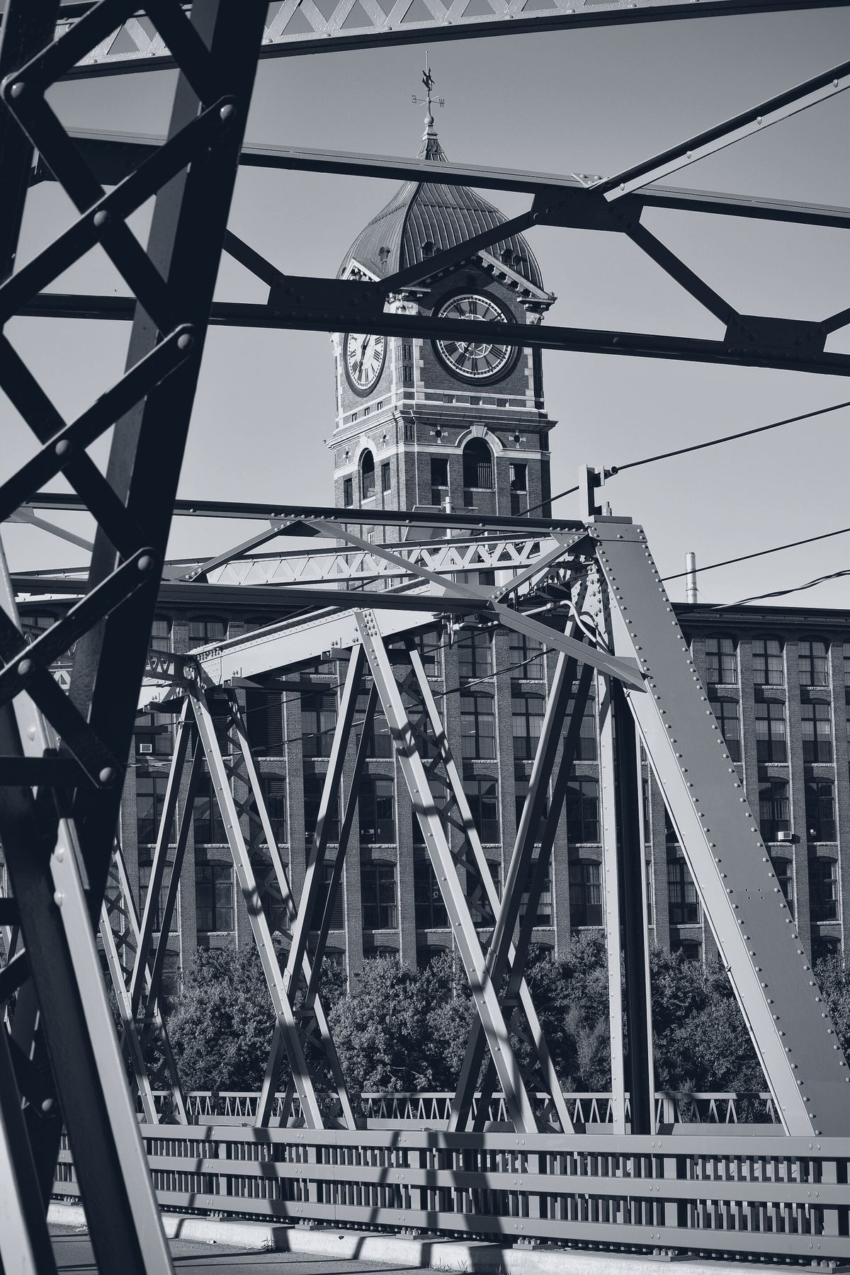 The Ayer Mill clock tower seen through the Duck Bridge trusses, Lawrence, MA